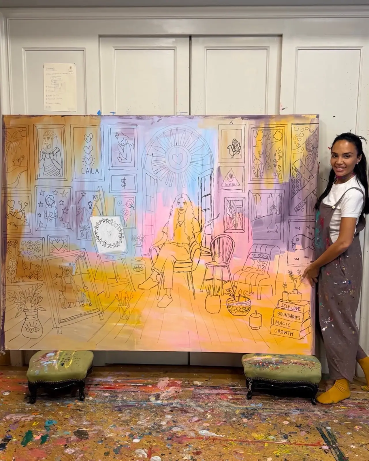 Laila beside a large sketched canvas in her studio